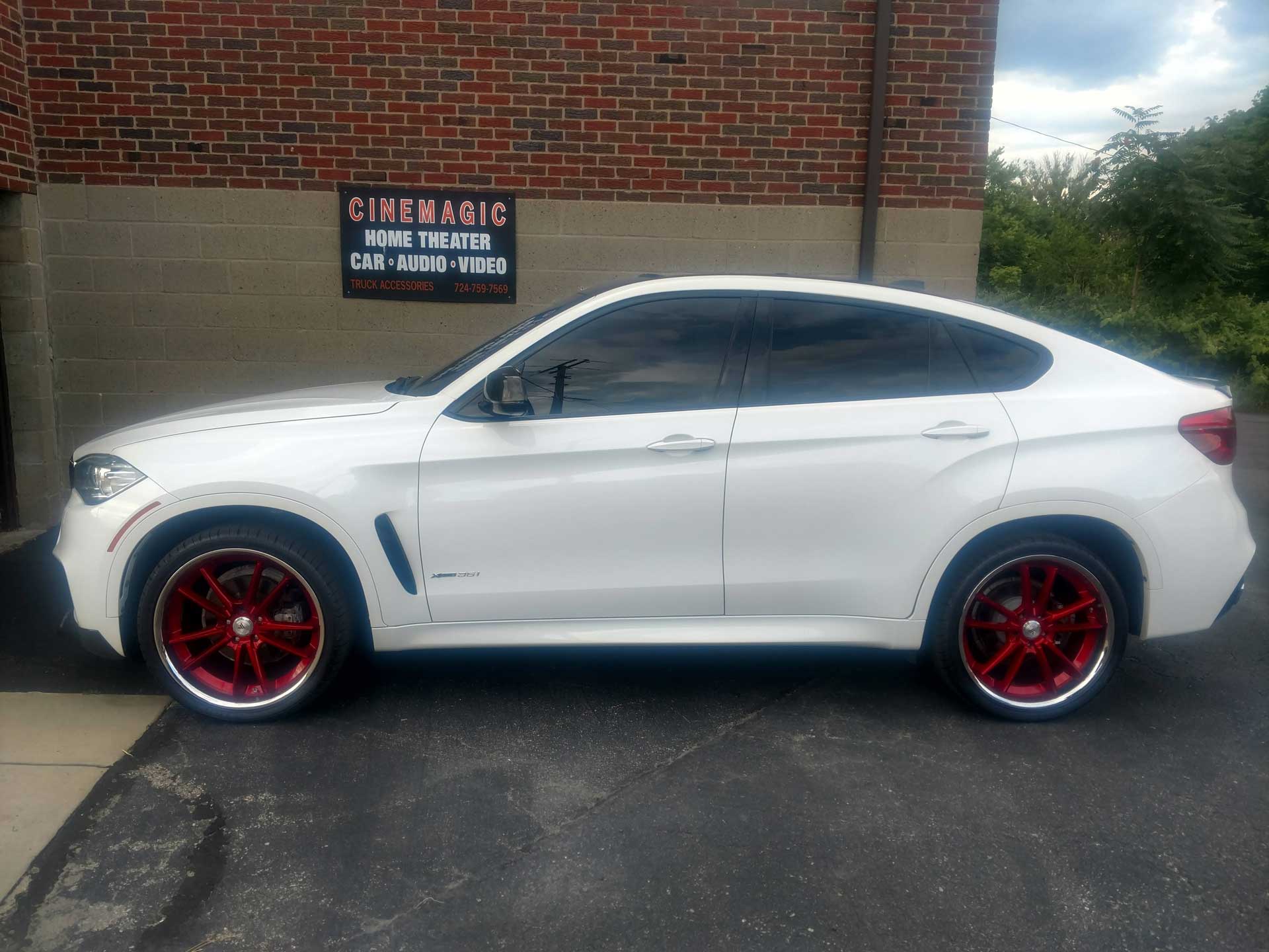 White car outside of Cinemagic Automotive Electronic's garage