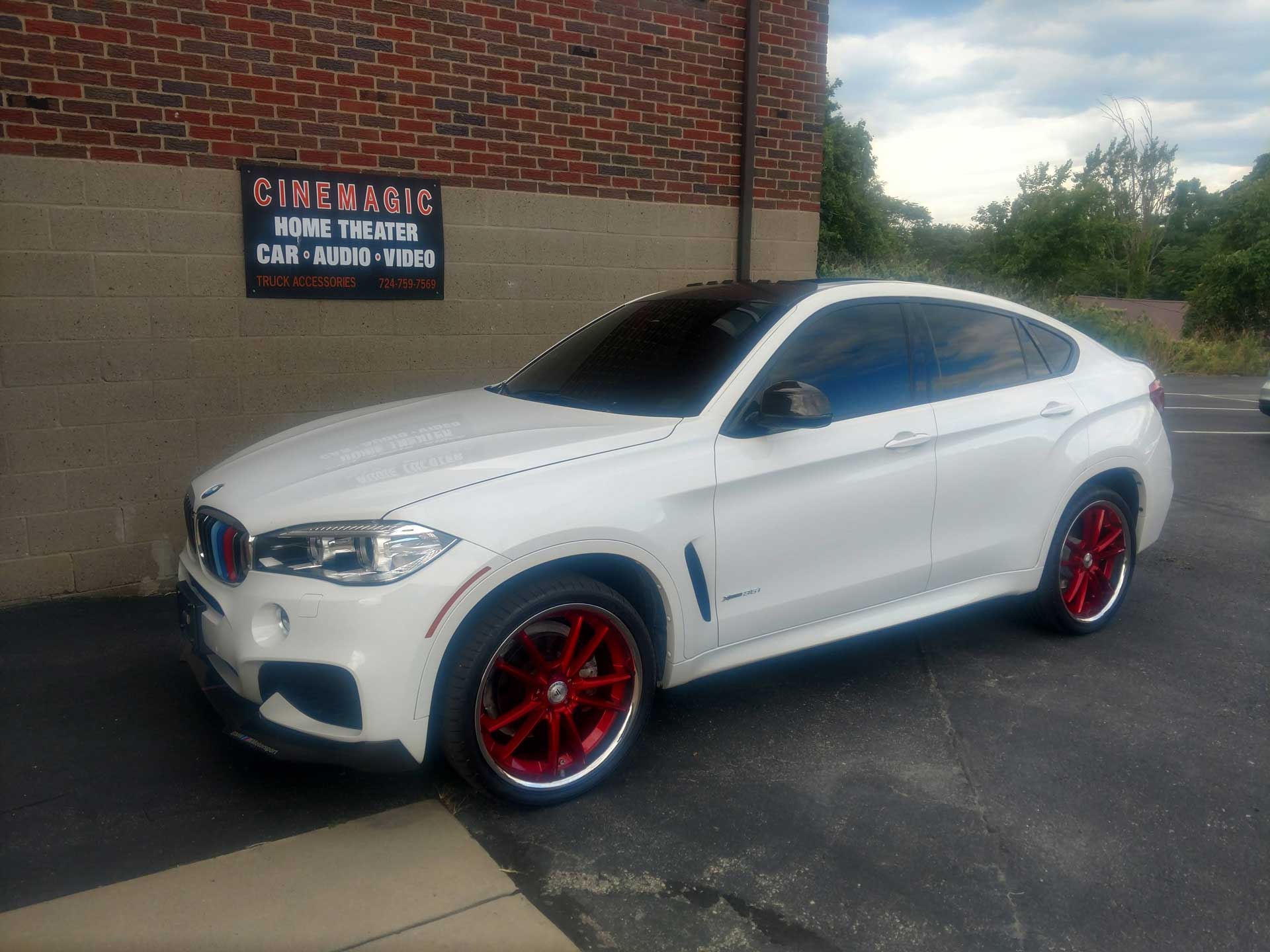 White car outside of Cinemagic Automotive Electronic's garage