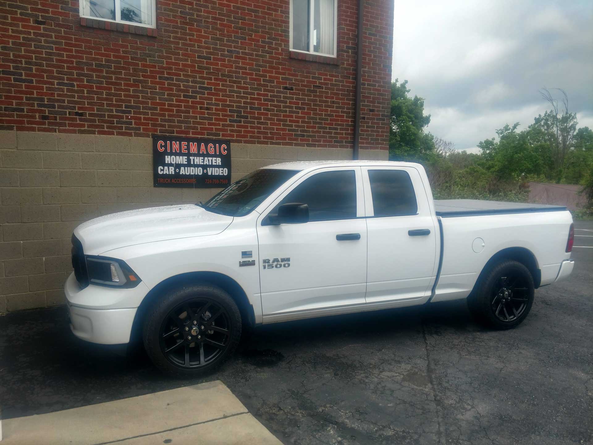 White truck outside of Cinemagic Automotive Electronic's garage